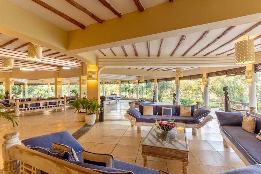 La lobby del 7 Islands Resort con divani e tavoli blu.
