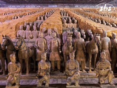 File di guerrieri e cavalli di terracotta a grandezza naturale sono disposti in formazione all'interno di un sito di scavi, una tappa obbligata di qualsiasi itinerario Cina Classica o Tour Il Triangolo Imperiale.